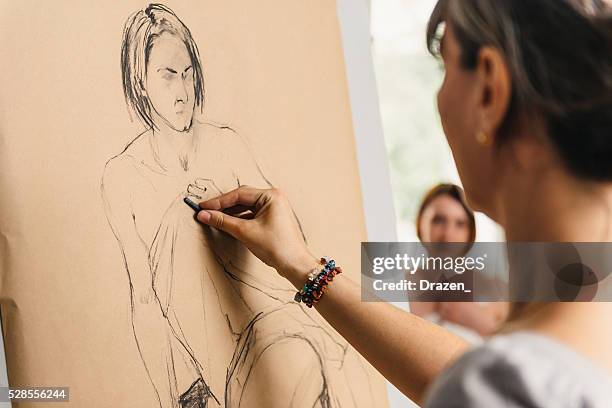 artists in atelier charcoal drawing semi nude model - charcoal stockfoto's en -beelden