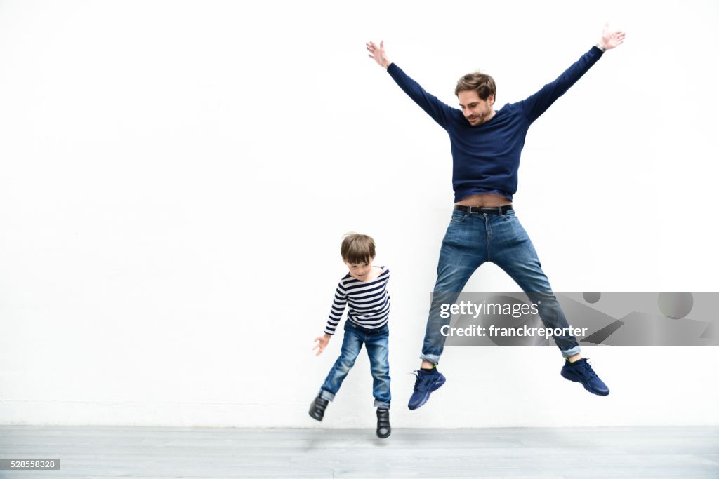 Father and son against the white wall