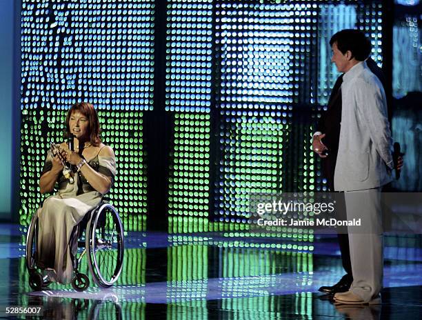 Paralympic athlete Chantal Petitclerc receives her Laureus World Sportsperson of the Year with a Disability award from actor Jackie Chan during the...