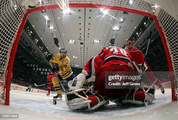 Goalkeeper Maxim Sokolov of Russia could not make the save as Henrik Sedin of Sweden takes a shot to score in the third period of the IIHF World...