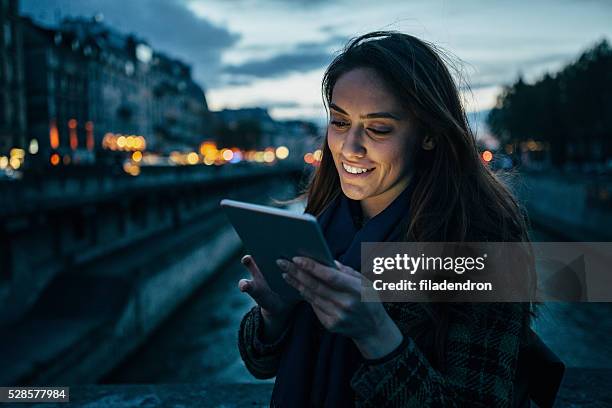 woman using tablet at night - surfing the net stock pictures, royalty-free photos & images