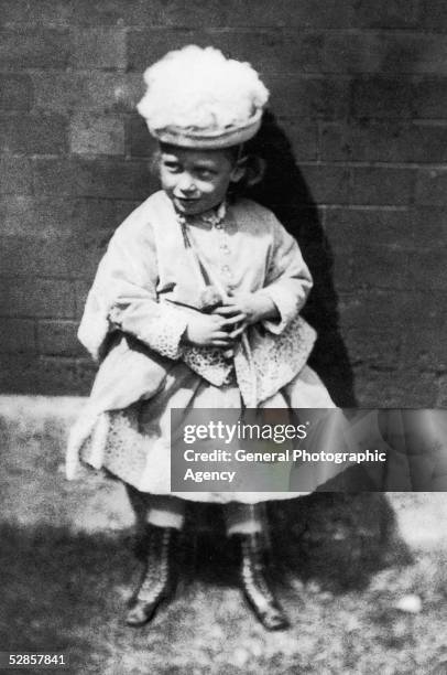 King George V of Great Britain in girl's clothing as a child, circa 1868.