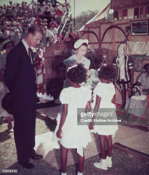 Queen Elizabeth II and Prince Philip, Duke of Edinburgh talking to Aboriginal girls in Townsville in Queensland during a Royal tour of Australia,...