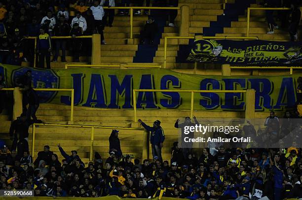 Fans of Boca Juniors display banners during a second leg match between Boca Juniors and Cerro Porteno as part of round of sixteen of Copa Bridgestone...