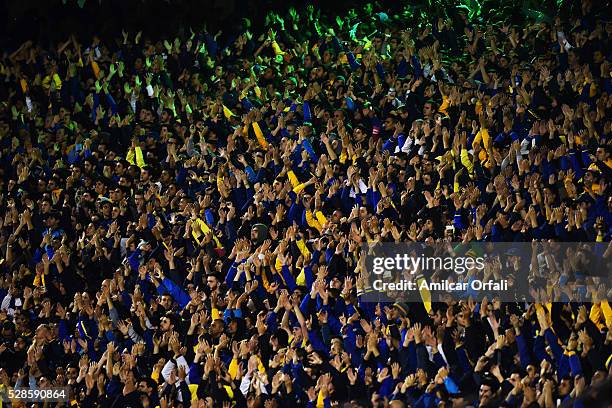 Fans of Boca Juniors cheer for their team during a second leg match between Boca Juniors and Cerro Porteno as part of round of sixteen of Copa...