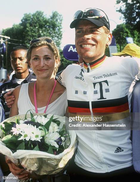 Gaby Weiss, girlfriend of leader of the Deutsche Telekom team German Jan Ullrich stands with Jan Ullrich at the beginning of the last stage of the...