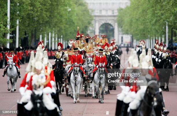 Soldiers of the Lifeguards accompany the Queen's carriage as it returns in ceremonial procession along the Mall after the State Opening of Parliament...