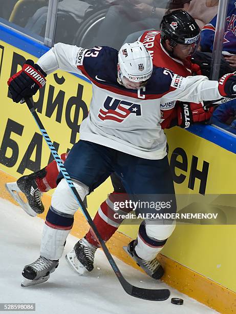 Forward Matt Hendricks vies with Canada's defender Ryan Murray during the group B preliminary round game USA vs Canada at the 2016 IIHF Ice Hockey...