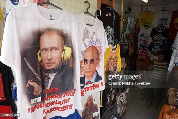 Shirts with a portrait of Russian President Vladimir Putin holding a gun are seen in a shop in the Black Sea resort of Sochi, Russia on May 5, 2016....