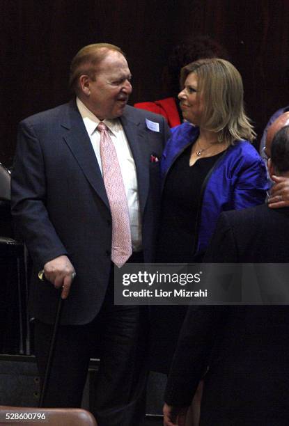 Philanthropist Sheldon Adelson hugs Sara Netanyahu, wife of Israeli Prime Minister Benjamin Netanyahu during the swearing of a new government in the...