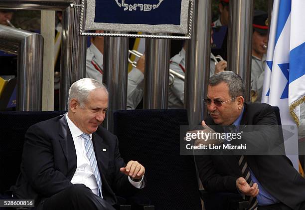 Israeli Prime Minister Benjamin Netanyahu speaks to Defence Minister Ehud Barak during a Independence Day Ceremony at the President house on April...