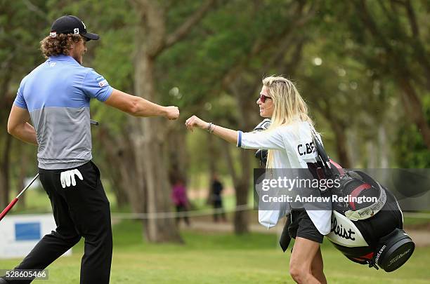 Clement Berardo of France bumps knuckles with hs caddie on the seventh hole during the second round of the Trophee Hassan II at Royal Golf Dar Es...