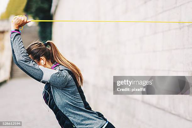 woman training with resistance band - rubber band stock pictures, royalty-free photos & images