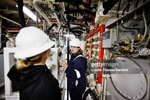 two female naval architects in discussion - genderblend2015 stock pictures, royalty-free photos & images