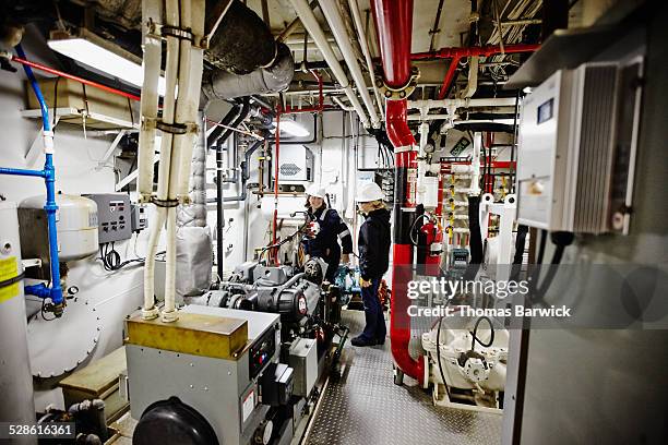 female naval architects in tugboat engine room - sleepboot stockfoto's en -beelden