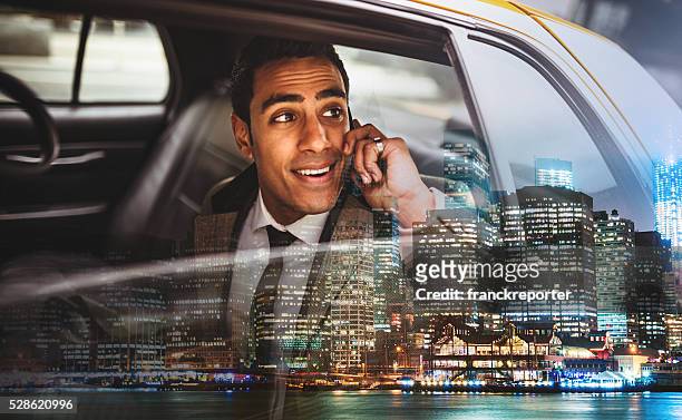 businessman on a yellow cab in new york city - asian man car stock pictures, royalty-free photos & images