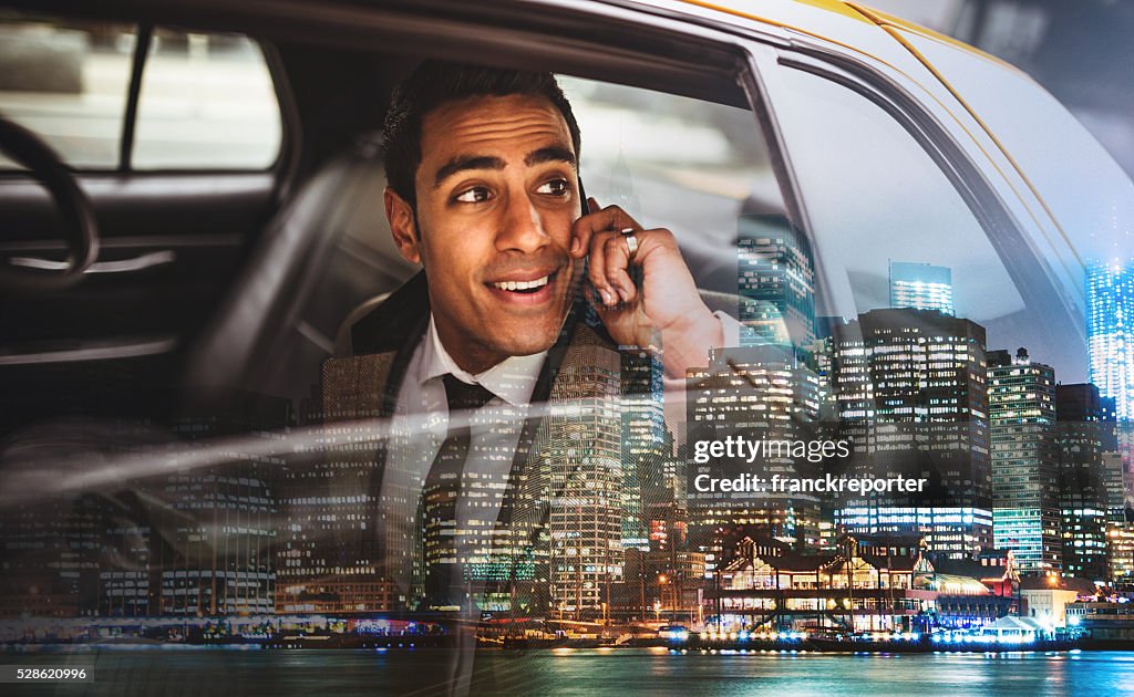 Businessman on a yellow cab in New York City