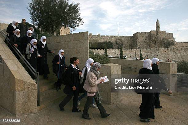 Palestinian school girls walk next to the Tower of David on January 24, 2011 in Old City of Jerusalem, Israel.