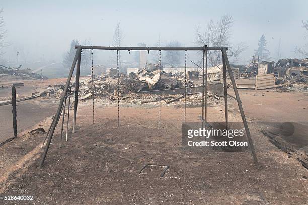 Swing set with the swings burned away sits in a residential neighborhood destroyed by a wildfire on May 6, 2016 in Fort McMurray, Alberta, Canada...