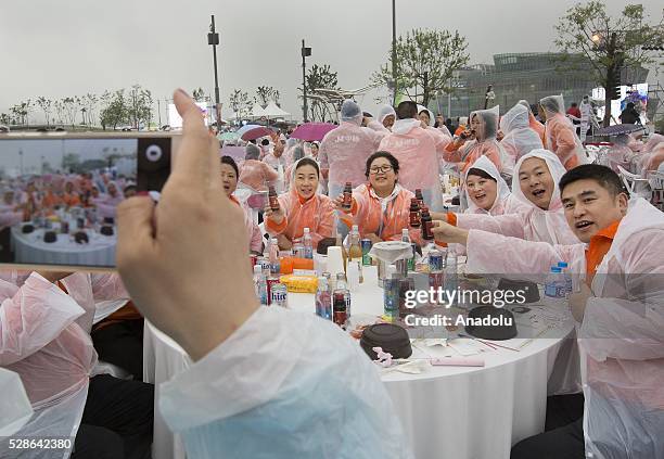Chinese visitors take photos as South Koreas capital Seoul is bustling with a huge group of tasting samgyetang in Seoul, South Korea on May 6, 2016....