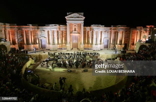 People attend a music concert in the ancient theatre of Syria's ravaged Palmyra on May 6, 2016 following its recapture by regime forces from the...