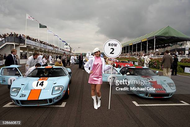 Line up on grid of the Whitsun Trophy, Oilexco grid girl between two 1965 Ford GT40 cars