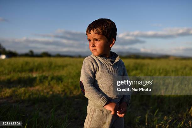 Syrian refugee kid stands in a field just next to Idomeni refugee camp on May 5'th, 2016. Thousands of migrants are still located in the makeshift...