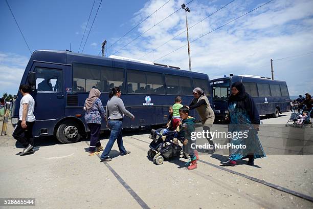 Refugees pass next to Police buses on May 6'th, 2016 at Idomeni refugee camp. Thousands of migrants are still stranded in the makeshift refugee camp,...