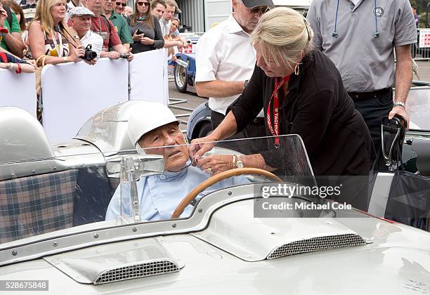Lady Susie Moss helping Sir Stirling with his helmet strap in the1955 Mille Miglia winning Mercedes Benz 300 SLR