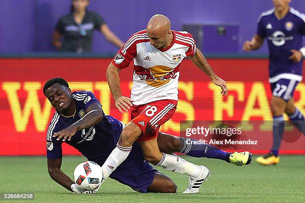 Aurelien Collin of New York Red Bulls knocks down Cyle Larin of Orlando City SC during an MLS soccer match at Camping World Stadium on May 6, 2016 in...