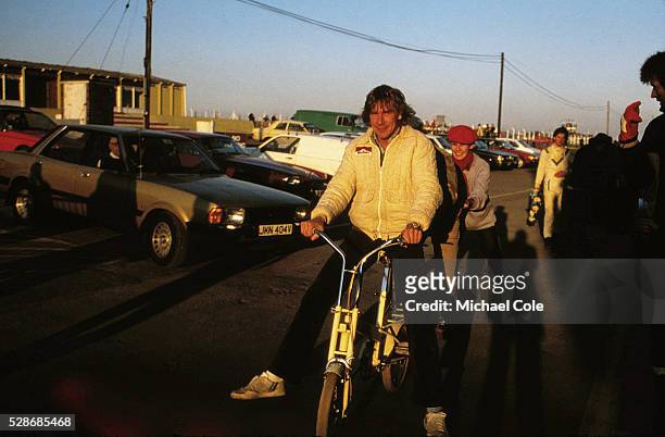 Racing Driver James Hunt on bicycle relaxing at home in Spain Feb 1979