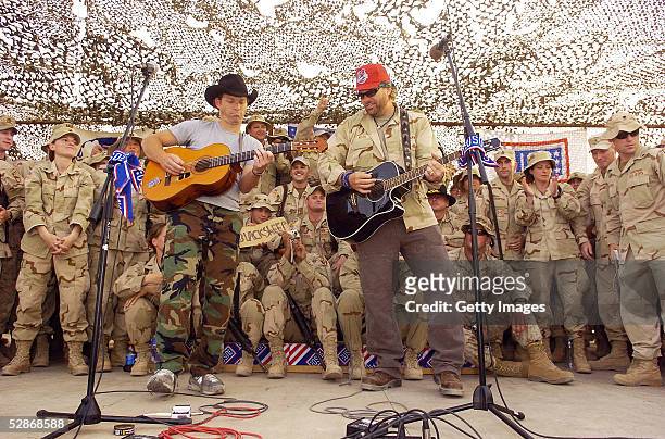 Country music star Toby Keith plays plays with Scotty Emerick during a United Service Organizations performance May 17, 2005 at Camp Victory in...