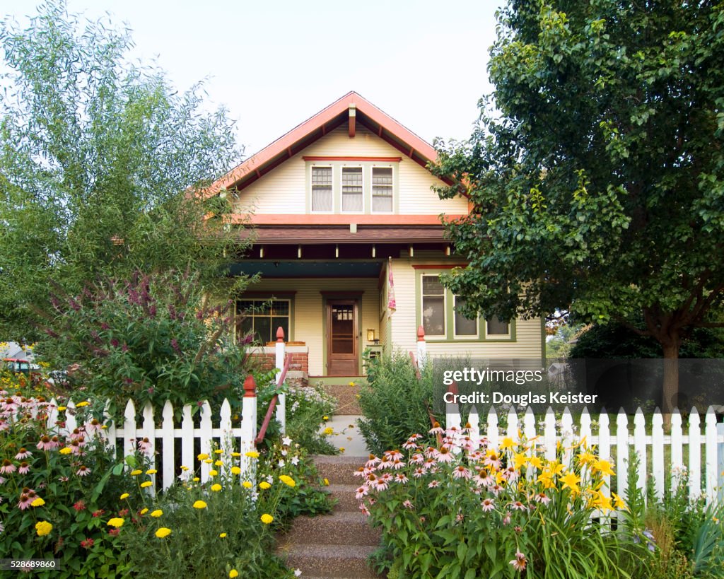 Bungalow House with White Picket Fence