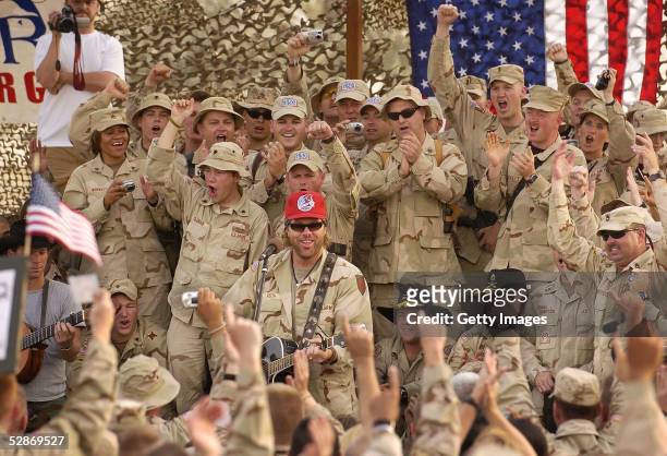 Country music star Toby Keith plays during a United Service Organizations performance May 17, 2005 at Camp Victory in Baghdad, Iraq. Keith taped a...