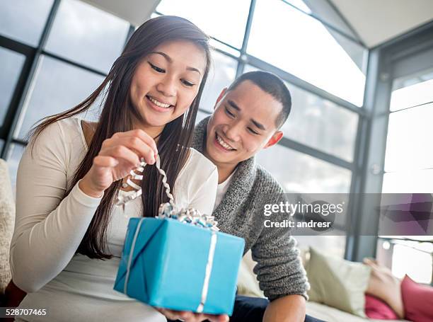 woman opening a gift - birthday present stock pictures, royalty-free photos & images