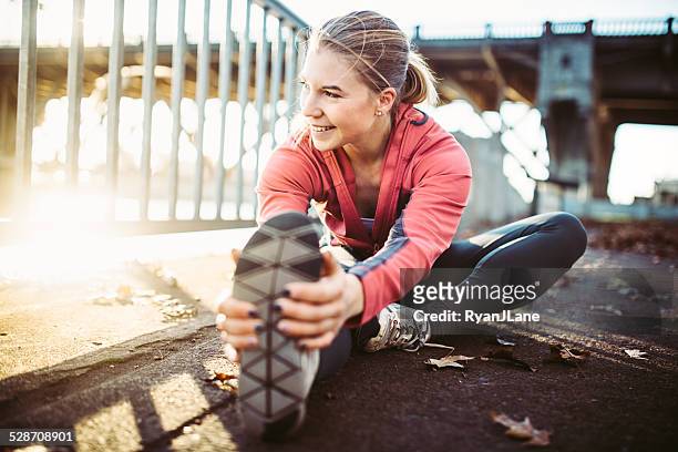 athlete stretching at portland waterfront - waterfront stockfoto's en -beelden