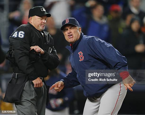 Manager John Farrell of the Boston Red Sox gestures at home plate umpire Ron Kulpa after David Ortiz argued a called strike by home plate umpire Ron...