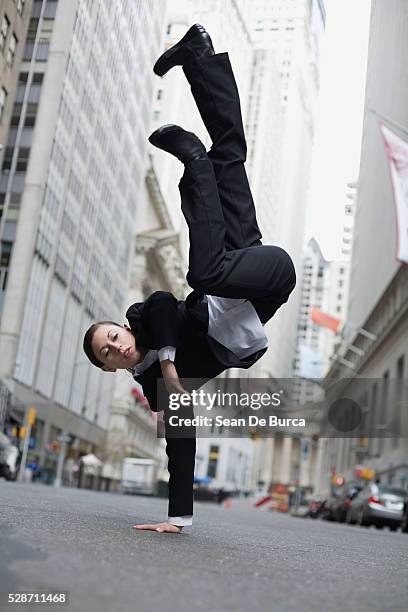 businesswoman breakdancing in street - break dance city stock pictures, royalty-free photos & images