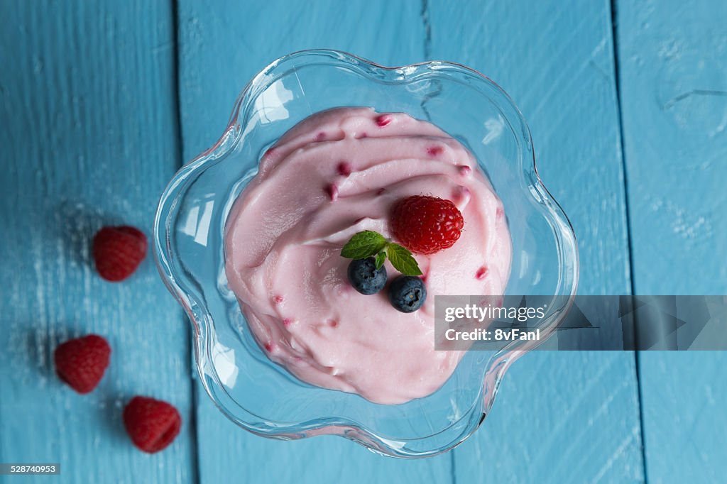 Raspberry cream dessert with mint and fruits