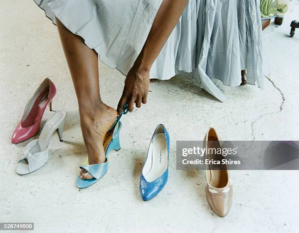woman trying shoes on - black shoe stock-fotos und bilder