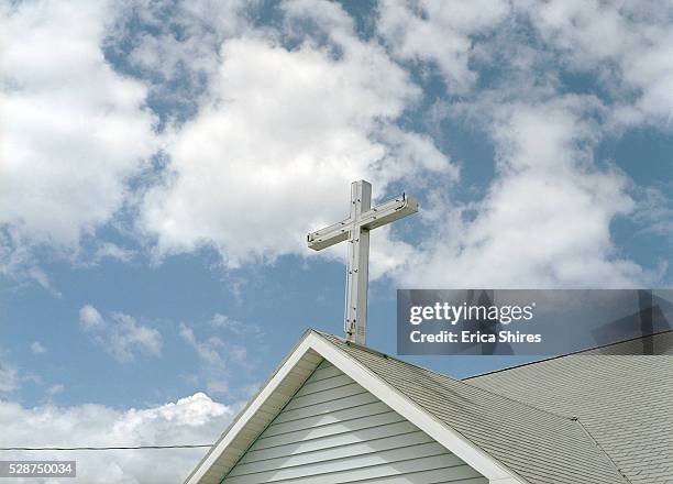 cross on top of a church - kirche stock-fotos und bilder