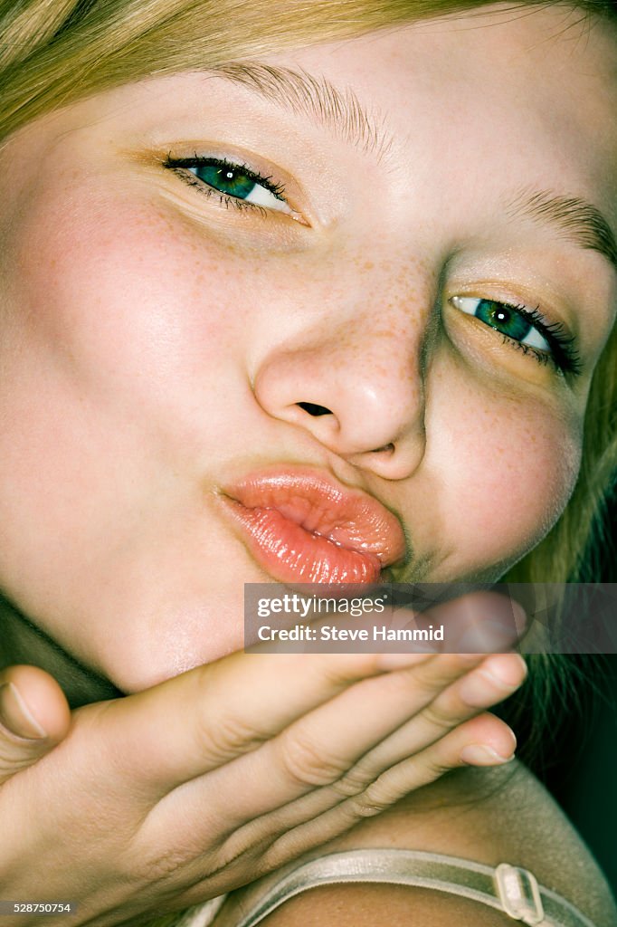 Young Woman Blowing Kiss