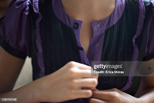 young woman unbuttoning blouse - purple blouse stock pictures, royalty-free photos & images