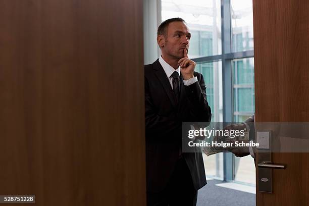 businessmen conducting bribe in conference room - bribing stock pictures, royalty-free photos & images