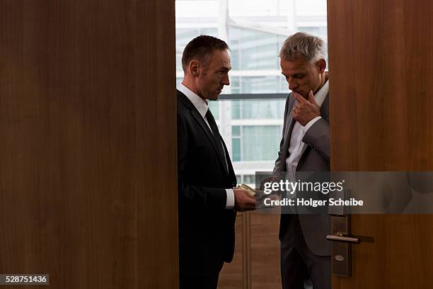 businessmen conducting bribe in conference room - 貪污 個照片及圖片檔