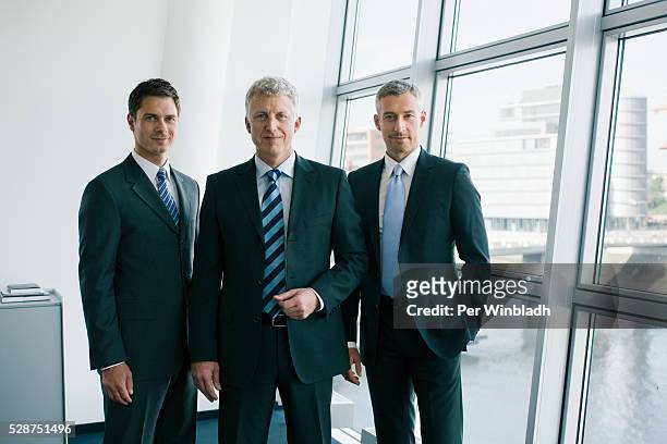 three reliable businessmen - drei personen stock-fotos und bilder