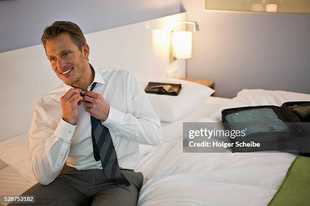 businessman loosening necktie - open collar stock pictures, royalty-free photos & images