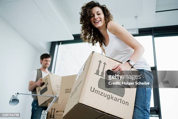 couple moving in to new home - woman carrying stock pictures, royalty-free photos & images