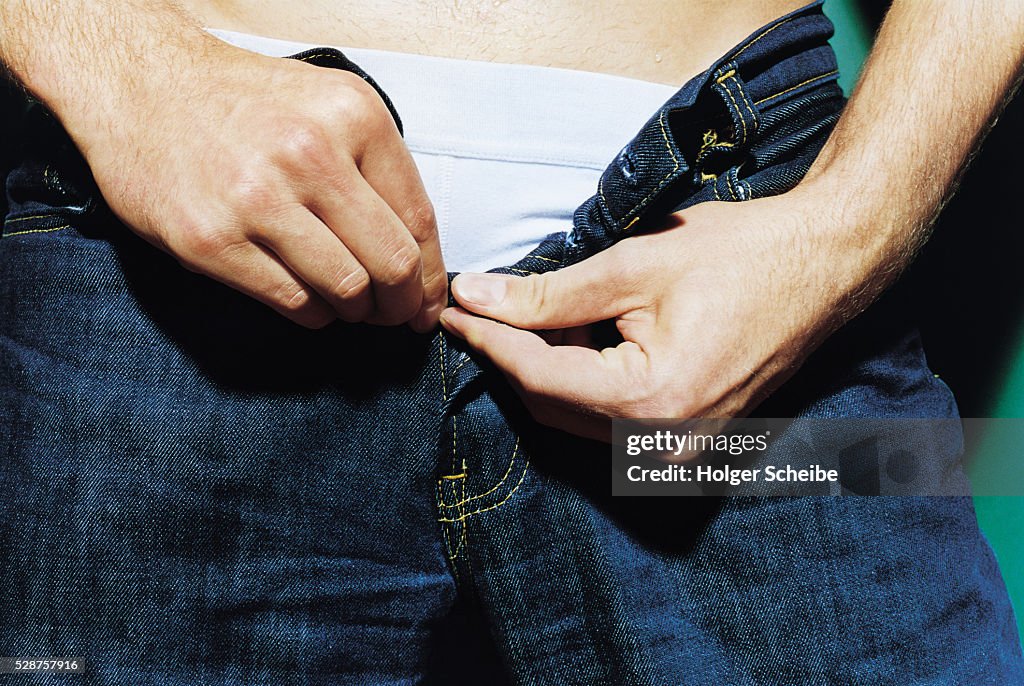 Young man with open pants