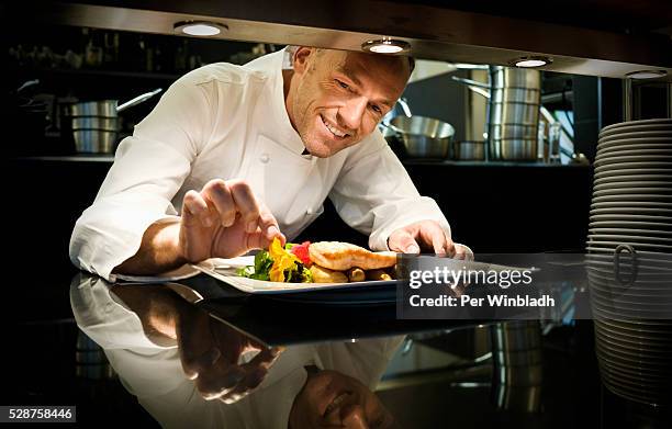 chef garnishing a meal - gourmet küche stock-fotos und bilder